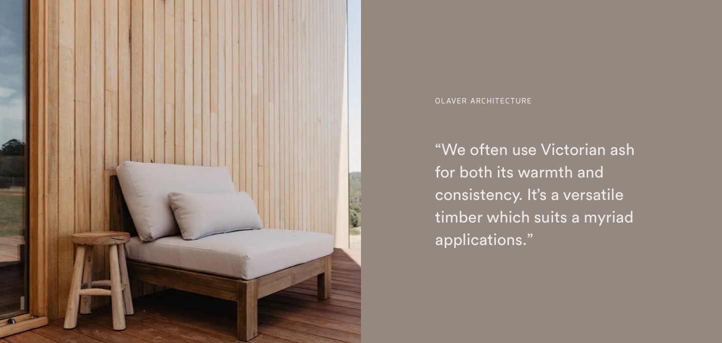 A timber deck with a timber wall behind it and a chair with a cream cushion on it.